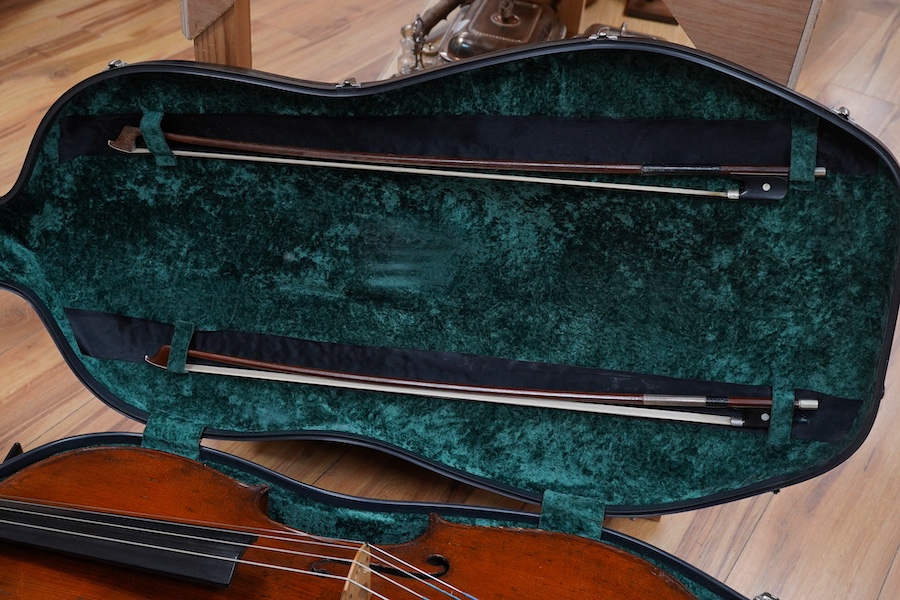 A cased late 19th century German? cello, body length 75cm, together with two bows. Condition - fair to good.